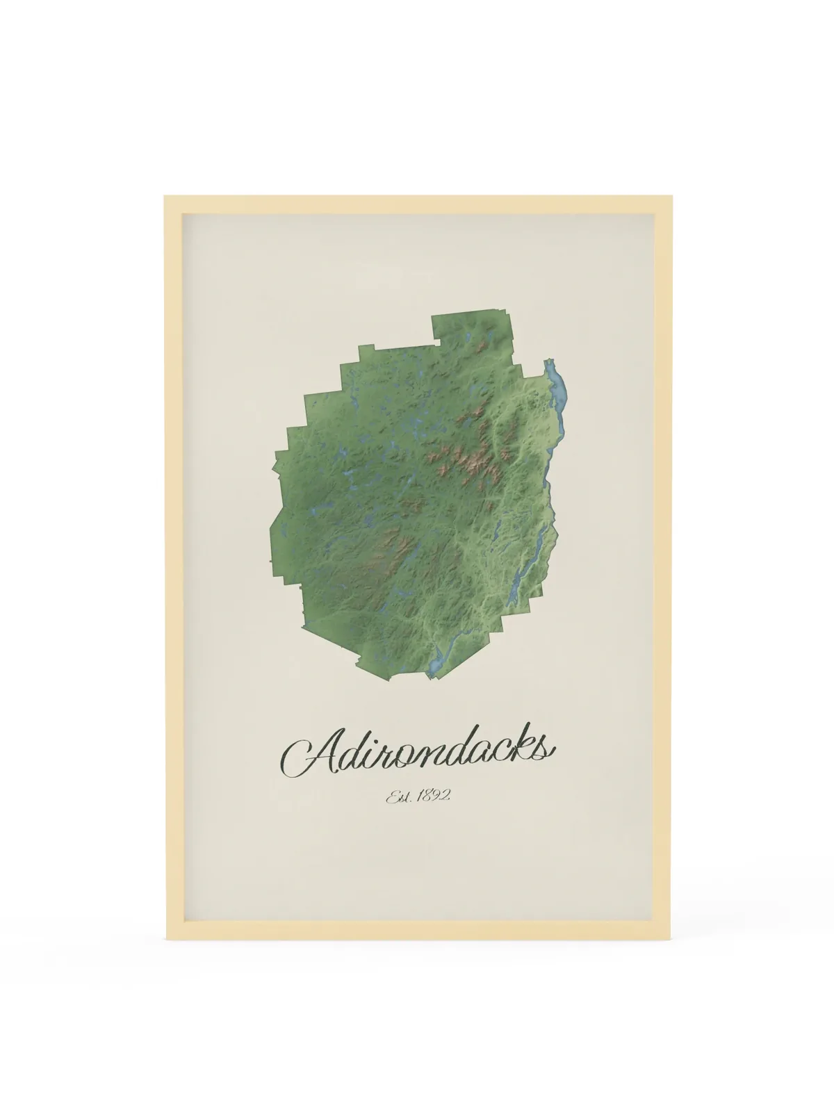 Adirondack Park Map as a 24 by 36 inch framed print in a natural wood frame: a painted-style map of the Adirondack Park with its lakes, rivers and High Peaks in green on cream paper, with Adirondacks, Est. 1892 in dark green script below.