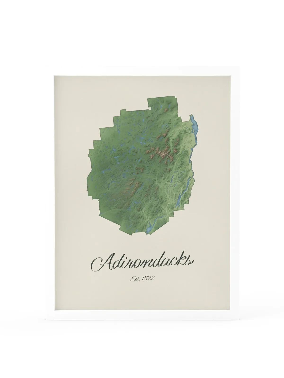 Adirondack Park Map as an 18 by 24 inch framed print in a white frame: a painted-style map of the Adirondack Park with its lakes, rivers and High Peaks in green on cream paper, with Adirondacks, Est. 1892 in dark green script below.