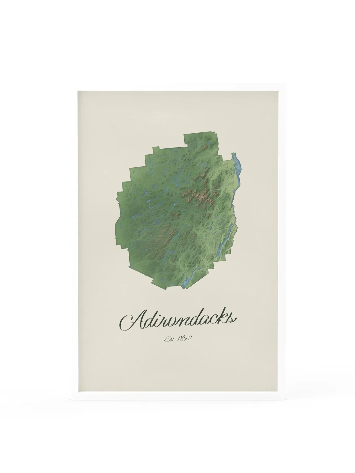 Adirondack Park Map as a 24 by 36 inch framed print in a white frame: a painted-style map of the Adirondack Park with its lakes, rivers and High Peaks in green on cream paper, with Adirondacks, Est. 1892 in dark green script below.