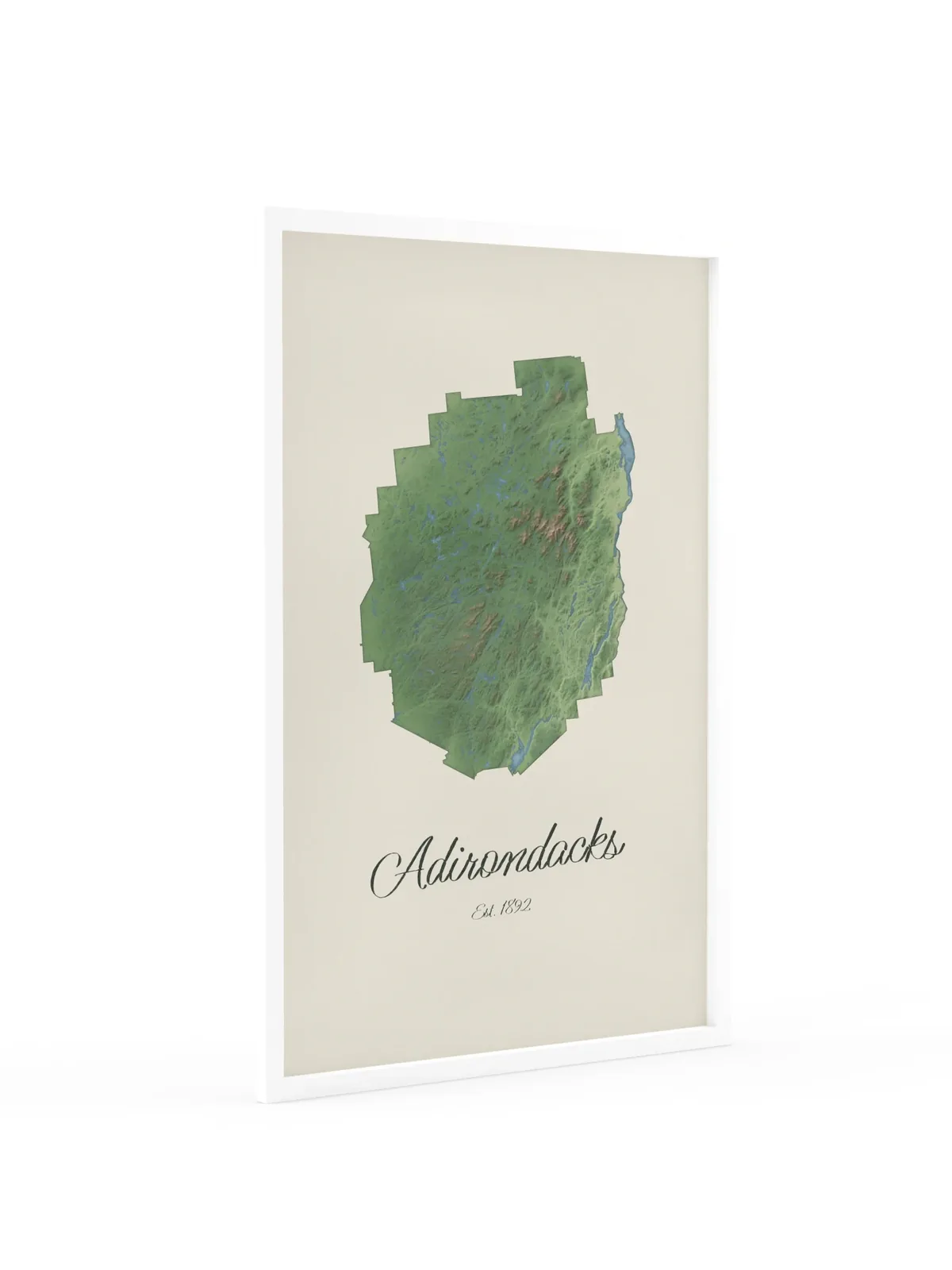 Adirondack Park Map as a 24 by 36 inch framed print in a white frame: a painted-style map of the Adirondack Park with its lakes, rivers and High Peaks in green on cream paper, with Adirondacks, Est. 1892 in dark green script below.