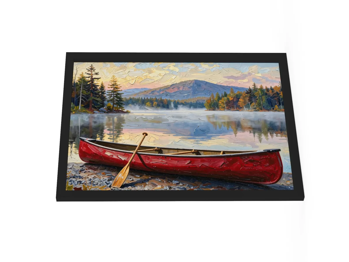Canoe in Morning Mist as an 18 by 24 inch framed print in a black frame: a red wooden canoe with a paddle leaning on it, on a lakeshore as morning mist lifts off a calm Adirondack lake below a mountain, in bold oil-painting brushstrokes.