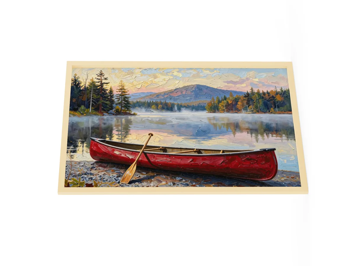 Canoe in Morning Mist as a 24 by 36 inch framed print in a natural wood frame: a red wooden canoe with a paddle leaning on it, on a lakeshore as morning mist lifts off a calm Adirondack lake below a mountain, in bold oil-painting brushstrokes.
