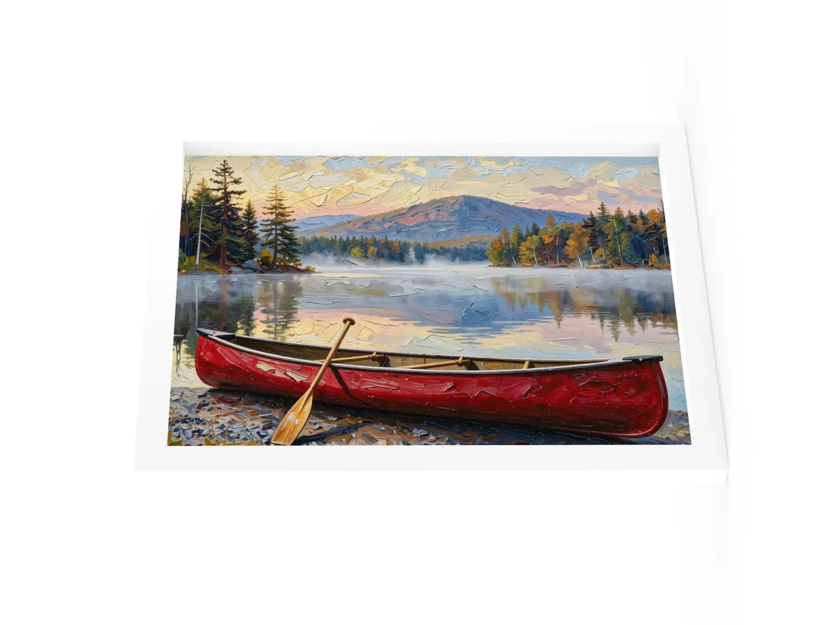 Canoe in Morning Mist as a 12 by 16 inch framed print in a white frame: a red wooden canoe with a paddle leaning on it, on a lakeshore as morning mist lifts off a calm Adirondack lake below a mountain, in bold oil-painting brushstrokes.
