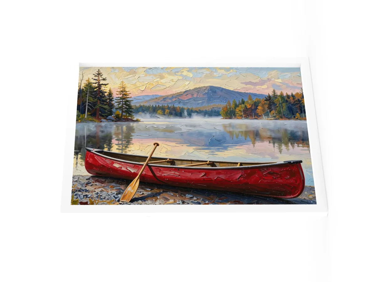 Canoe in Morning Mist as an 18 by 24 inch framed print in a white frame: a red wooden canoe with a paddle leaning on it, on a lakeshore as morning mist lifts off a calm Adirondack lake below a mountain, in bold oil-painting brushstrokes.