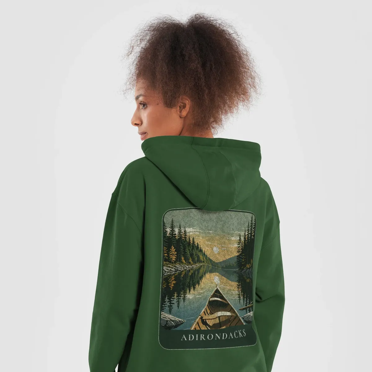 Canoe Sunset Hoodie in Forest Green, back: the bow of a wooden canoe on an Adirondack lake at sunset, Adirondacks.