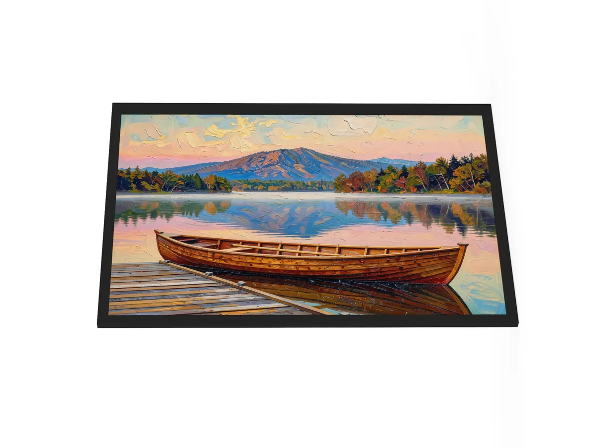 Guideboat at Dawn as a 24 by 36 inch framed print in a black frame: a varnished wooden Adirondack guideboat tied alongside a dock at dawn, with mist on a still lake and a mountain in pink light, in bold oil-painting brushstrokes.
