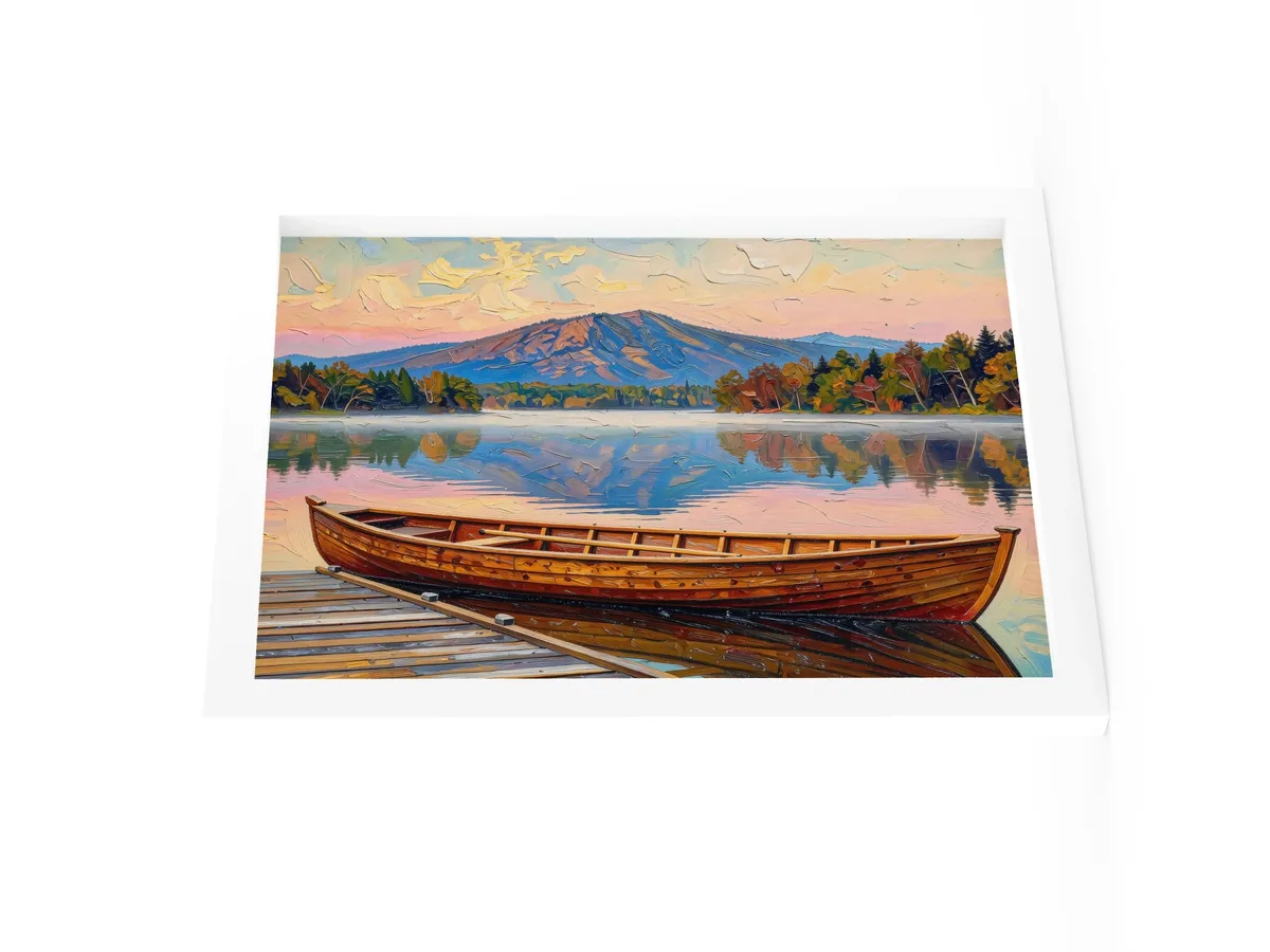 Guideboat at Dawn as a 12 by 16 inch framed print in a white frame: a varnished wooden Adirondack guideboat tied alongside a dock at dawn, with mist on a still lake and a mountain in pink light, in bold oil-painting brushstrokes.