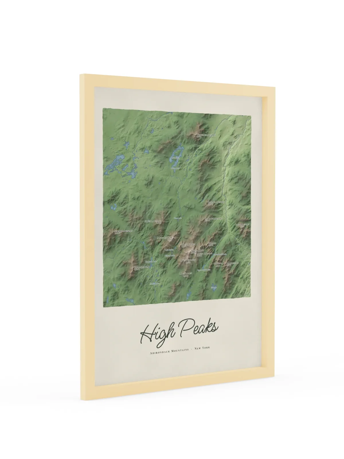 High Peaks Map as an 18 by 24 inch framed print in a natural wood frame: a painted map of the Adirondack High Peaks with the summits shaded and sixteen peaks named with their heights, lakes and rivers in blue, with High Peaks lettered below in dark green script.