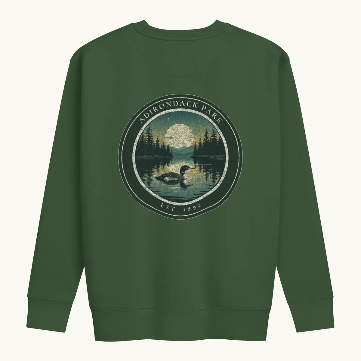 Loon at Night Crewneck in Forest Green, back: a loon on a moonlit Adirondack lake in a round badge, Adirondack Park, Est. 1892.