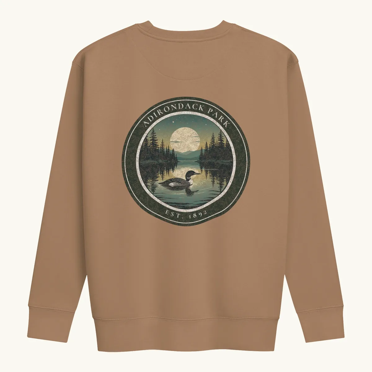 Loon at Night Crewneck in Latte, back: a loon on a moonlit Adirondack lake in a round badge, Adirondack Park, Est. 1892.