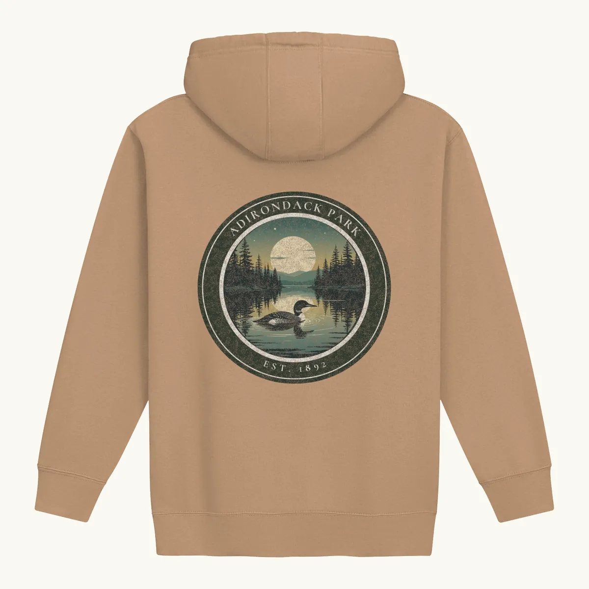Loon at Night Hoodie in Latte, back: a loon on a moonlit Adirondack lake in a round badge, Adirondack Park, Est. 1892.