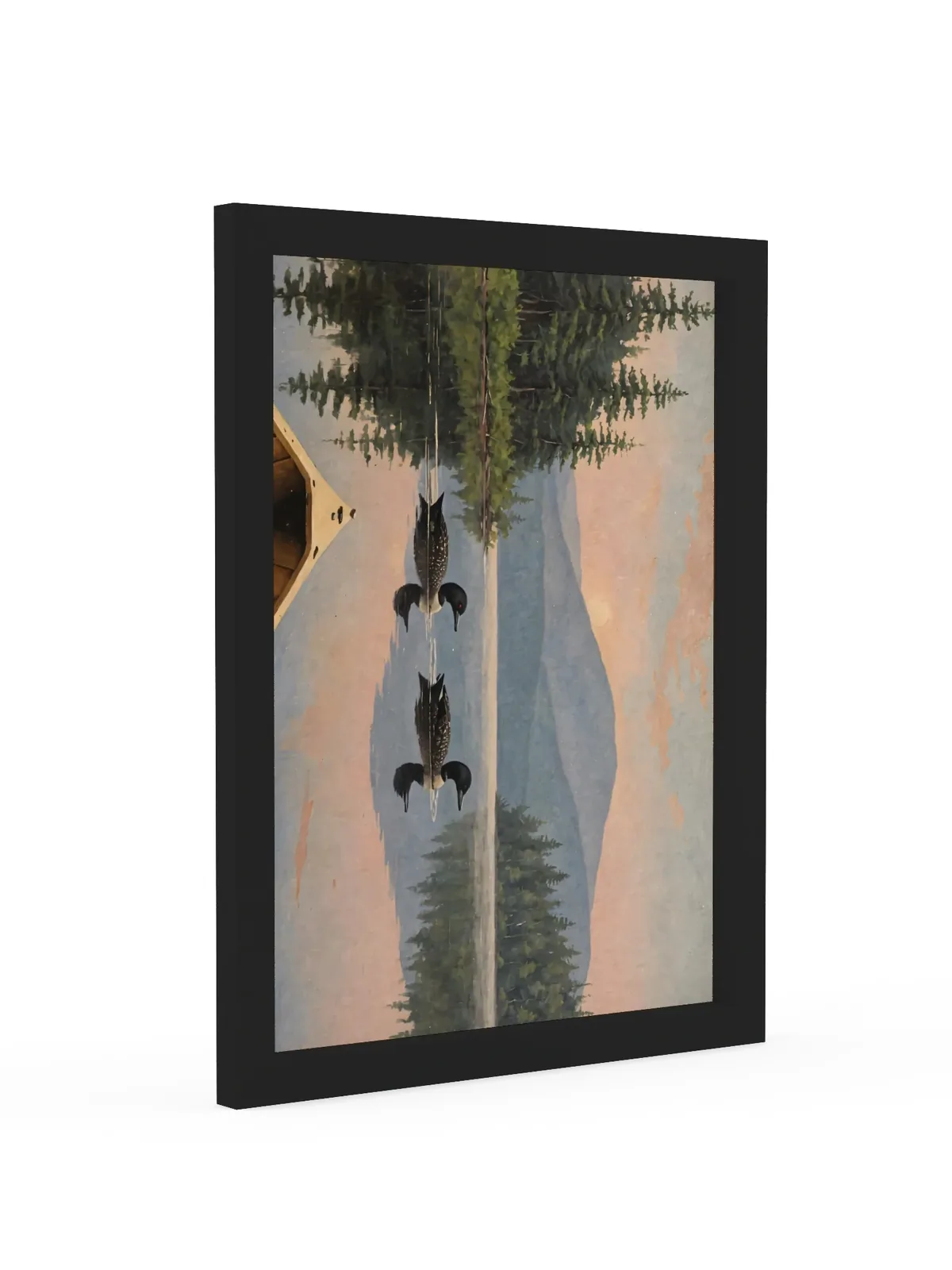 Loon Pair at Sunrise as a 12 by 16 inch framed print in a black frame: two common loons swimming side by side across a still Adirondack lake at sunrise, seen from the bow of a wooden canoe, with spruce shores, a blue mountain and a peach-pink sky doubled in the water, in soft, traditional oil brushwork.