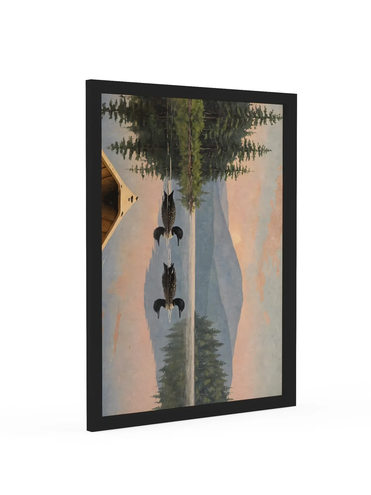 Loon Pair at Sunrise as an 18 by 24 inch framed print in a black frame: two common loons swimming side by side across a still Adirondack lake at sunrise, seen from the bow of a wooden canoe, with spruce shores, a blue mountain and a peach-pink sky doubled in the water, in soft, traditional oil brushwork.