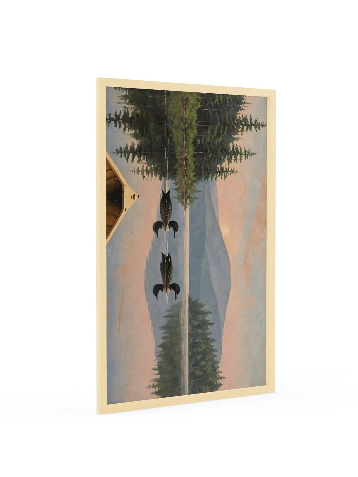 Loon Pair at Sunrise as a 24 by 36 inch framed print in a natural wood frame: two common loons swimming side by side across a still Adirondack lake at sunrise, seen from the bow of a wooden canoe, with spruce shores, a blue mountain and a peach-pink sky doubled in the water, in soft, traditional oil brushwork.