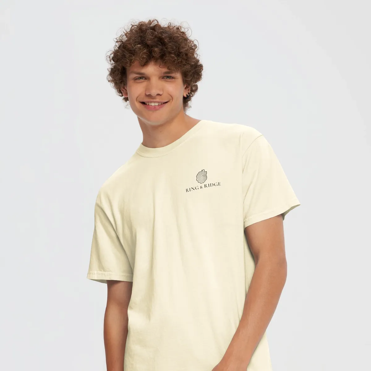 Tree Ring Tee in Ivory, front: the Ring & Ridge tree rings in the shape of the Adirondack Park.